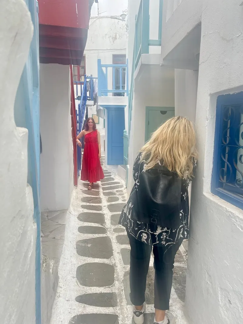 Photographer reviewing frames with clients at the Old Port on a custom Mykonos photoshoot